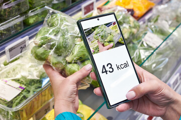 Checking calories on brussels sprout vegetable with smartphone