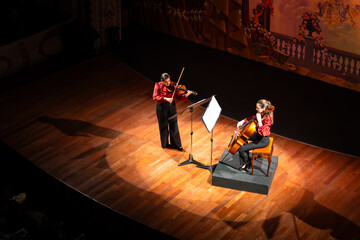 Classical music concert. Two musicians fill the theater with the public.