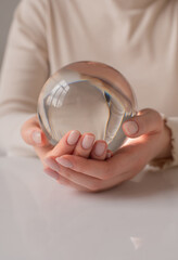 close up a person holds in hands glass ball