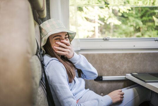 Caucasian Girl Laughing While Seating Inside a Camper Van