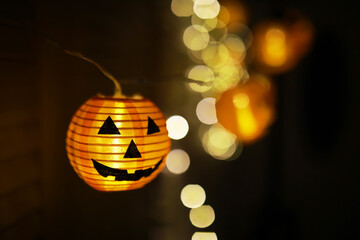 The concept of light on the night Halloween.Round lamp shape of pumpkin used to decorate with bokeh...