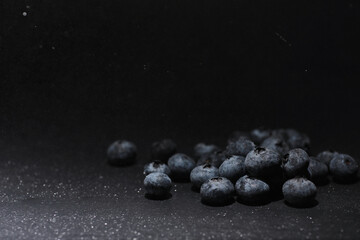 Water drops on ripe sweet blueberry. Fresh blueberries background with copy space for your text. Vegan and vegetarian concept. Macro texture of blueberry berries. - obrazy, fototapety, plakaty