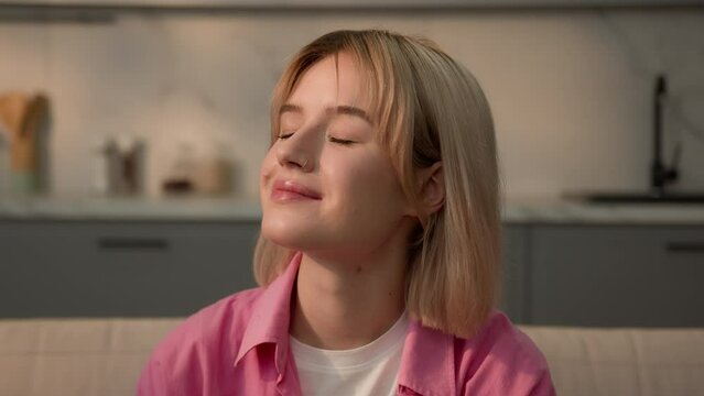 Dreamy inspired happy smiling calm peaceful dreaming relaxing Caucasian teen student girl woman lady female homeowner renter home apartment enjoy air conditioner dream eyes closed smell mental health