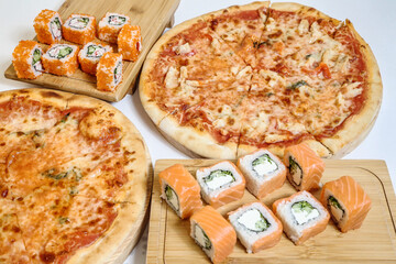 Table Adorned With a Variety of Pizzas and Sushi Rolls.