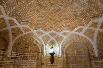 Historical hammam in Bukhara. Vintage brick vault ceiling with hanging lantern, warm tones, perfect...