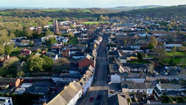 Aerial drone footage of Cullompton in Devon, England. Reverse shot over the High Street