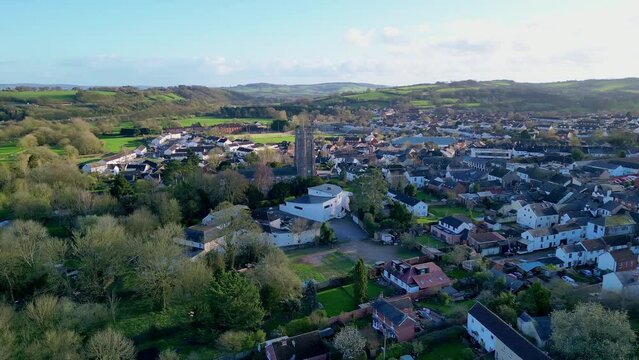 Aerial drone footage of the town of Cullompton in Devon, England. Orbit around St Andrew's Church and Fore Street