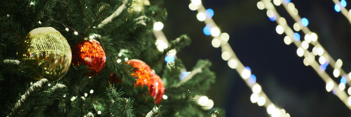 New Year christmas tree decorated Christmas balls with yellow flickering lights of garlands copy...