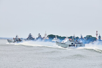Military warship sailing along Russian naval forces parade warships along coastline, seafaring tradition of military ships formation along shore, nautical spectacle of russian sea power