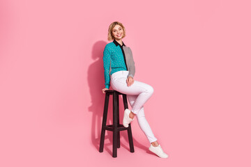 Full size photo of pretty young girl girlish posing model sit chair wear trendy striped cyan outfit isolated on pink color background - obrazy, fototapety, plakaty