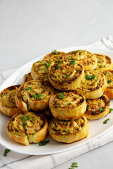 Homemade Chicken Pesto Pinwheels on a Plate, side view. Copy space.