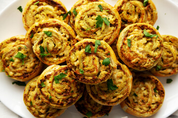 Homemade Chicken Pesto Pinwheels on a Plate, top view. Flat lay, overhead, from above.