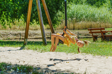 Cute perky preschooler boy having fun on outdoor playground. Spring or summer active sport leisure for kids. Outdoor leisure activities.
