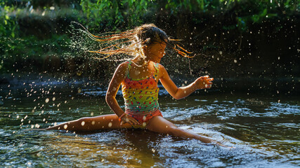  little girl playing in the river. A girl with blond hair in a sunbeam surrounded by thousands of small drops. - obrazy, fototapety, plakaty