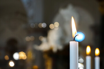 Close up of burning candles inside a church