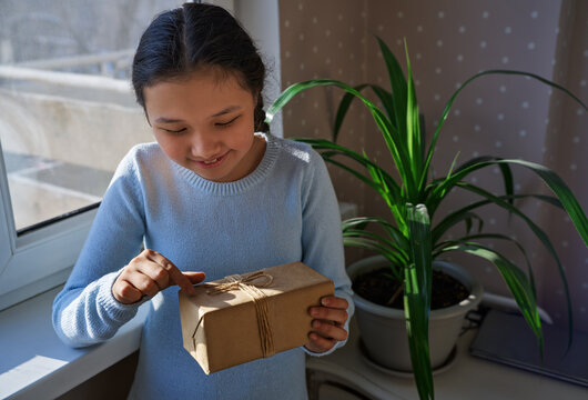 Girl delighted by a surprise gift at home
