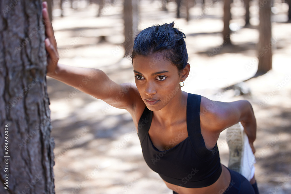 Sticker Exercise, tree and woman in forest, serious and outdoor for stretching, nature and healthy with wellness. Training, performance and Indian person, girl and strong in weekend, fitness and sports