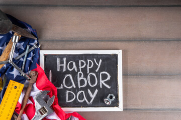 American National Patriotic Workers Happy Labor day Holiday background. Construction and manufacturing tools on wooden background with stars, red white blue striped US flag