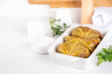 Homemade Stuffed cabbage rolls on white table. Cabbage rolls with meat or vegetables with rice, balanced healthy food recipe