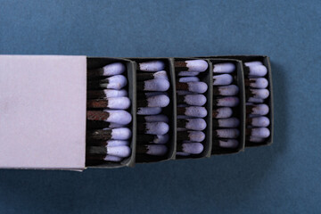 top view lilac matchboxes stacks up on a blue background