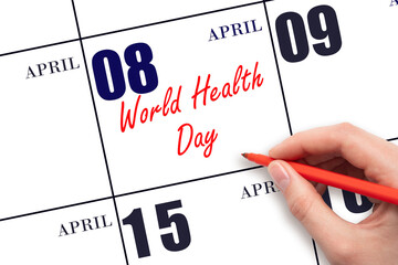 April 8. Hand writing text World Health Day on calendar date. Save the date.