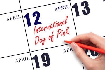 April 12. Hand writing text International Day of Pink on calendar date. Save the date.