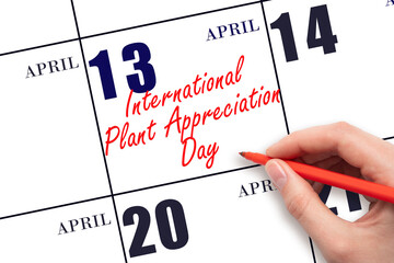 April 13. Hand writing text International Plant Appreciation Day on calendar date. Save the date.