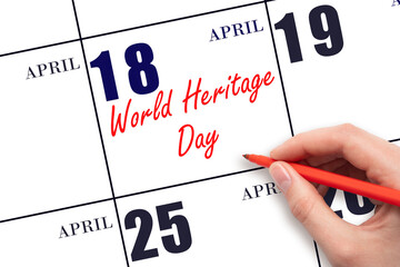 April 18. Hand writing text World Heritage Day on calendar date. Save the date.