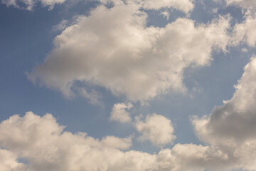The sky is filled with clouds, and the sun is shining through them