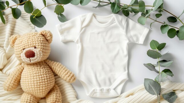 Blank infant onesie mockup with teddy bear, eucalyptus branch on ivory blanket background