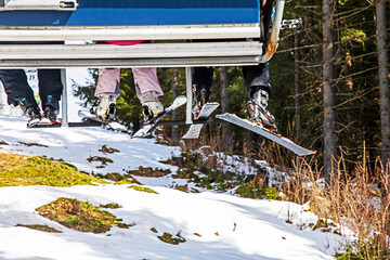 close-up of skiers on a ski lift going to the slope for a ride. Active recreation with the family....