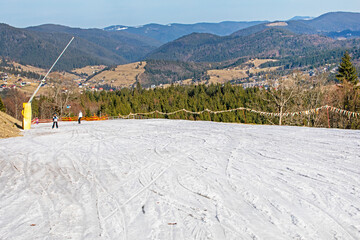 skiers on a snow slope for beginners on a sunny day. active recreation