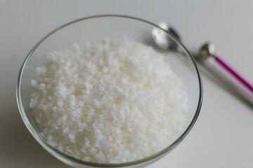 close-up of candle wax in granules on a light background