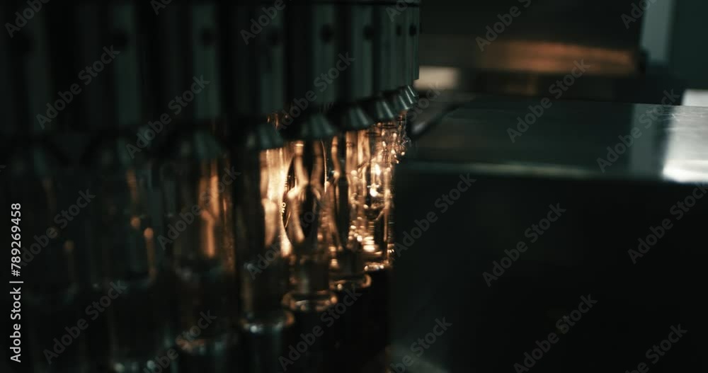 Aufkleber a bottling machine is filling plastic bottles with liquid in a large factory bottling plant. industr