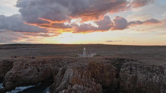 Punta Nati Lighthouse, north of Menorca Spain Gradient pale tones skyline cliff rocky shore sea landscape aerial drone view