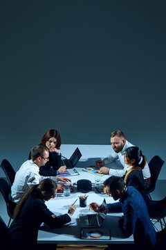 Vertical flyer with copy space. Employees meeting in boardroom in office, sitting at table and discussing project issues. Concept of business, entrepreneurship, communication, teamwork