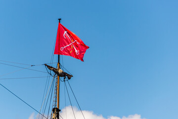 Flag of St. Petersburg, Russia, on the mast of an ancient ship.