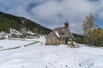 Little chapel in the mountains with great panoramic view over Bregenz forest. alpine scenery with...