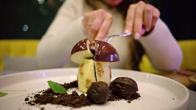 Woman cutting up chocolate mushroom desert at a restaurant