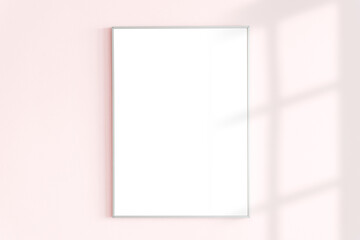Blank frame on a pink wall with natural light