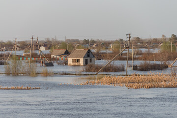 Flood in Kazakhstan. Flooded houses in a dacha area. The river overflowed its banks. Cataclysms in...