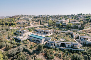 Two-tier hotel with terraces, columns and swimming pools. Amanzoe, Peloponnese, Greece. Drone