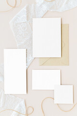 Blank paper notes on a white lace fabric