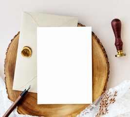 Card mockup with beige envelope on a wooden plate