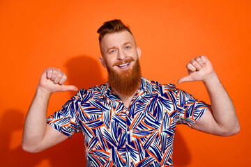 Photo of positive confident guy dressed print shirt showing thumbs himself isolated orange color...