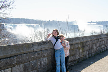 Tourists, them back to the camera, looking into the tower view at the Niagara Falls from the...