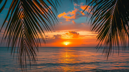 Fototapeta na wymiar Sunset on the beach with tropical palm tree leaves, calm ocean horizon