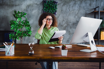 Photo of dreamy lovely woman office manager sitting working holding checklist blank list workspace...