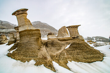 Winter clings to the hoodoos as spring arrives in the badlands. Drumheller Alberta, Canada.
