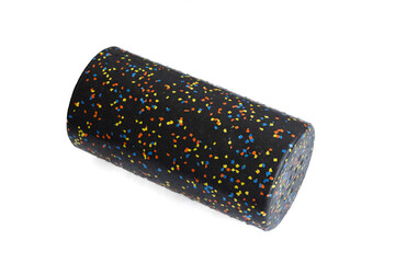 A black massage foam roller isolated on a white background. Close-up. Foam rolling is a self...